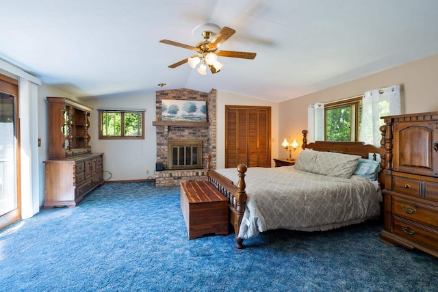 W2761 49th St, Mauston, WI 53948 - bedroom featuring multiple windows, carpet floors, lofted ceiling, a fireplace, and a ceiling fan
