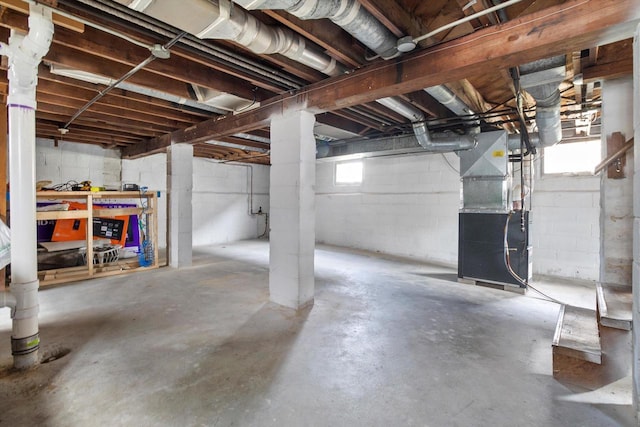 901 William St, Racine, WI 53402 - below grade area featuring heating unit and concrete block wall