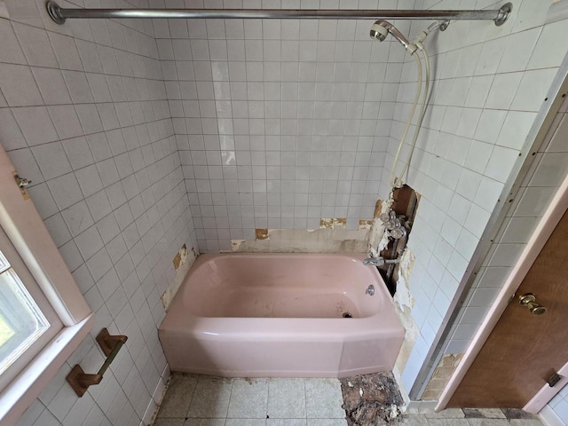 6455 N 56th St, Milwaukee, WI 53223 - bathroom featuring tile walls, bathing tub / shower combination, and tile patterned flooring