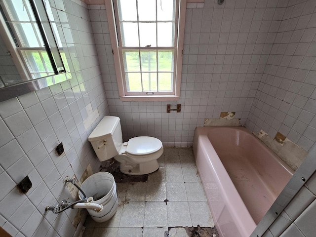 6455 N 56th St, Milwaukee, WI 53223 - full bath featuring toilet, a bath, plenty of natural light, tile patterned flooring, and tile walls