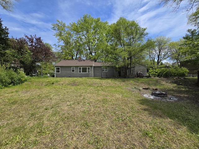 6455 N 56th St, Milwaukee, WI 53223 - view of grassy yard featuring a fire pit