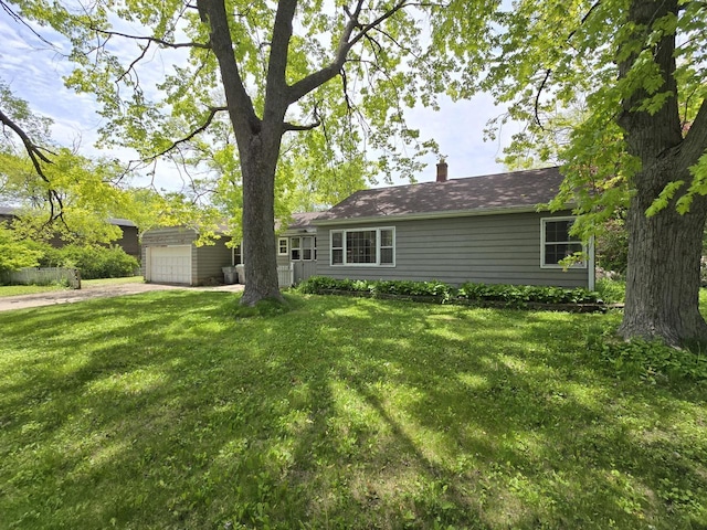 6455 N 56th St, Milwaukee, WI 53223 - view of green lawn with an attached garage and driveway