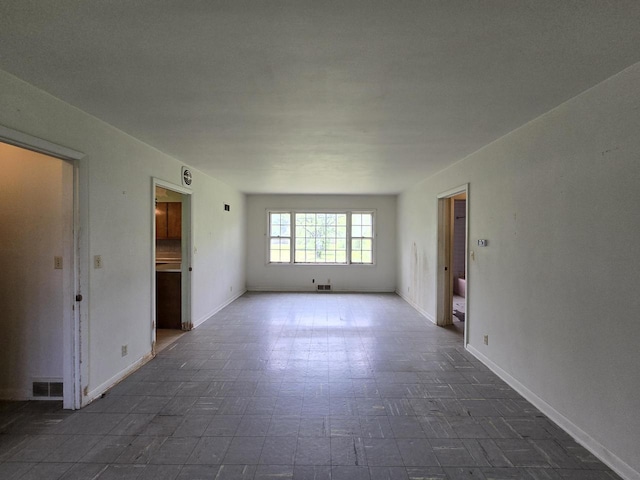 6455 N 56th St, Milwaukee, WI 53223 - spare room featuring baseboards and dark flooring