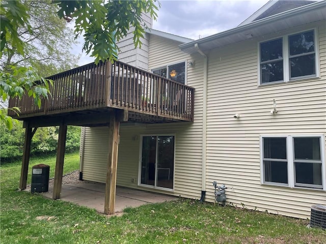 1762 Wilson Ave, Menomonie, WI 54751 - rear view of house featuring a patio area, a deck, a lawn, and central air condition unit