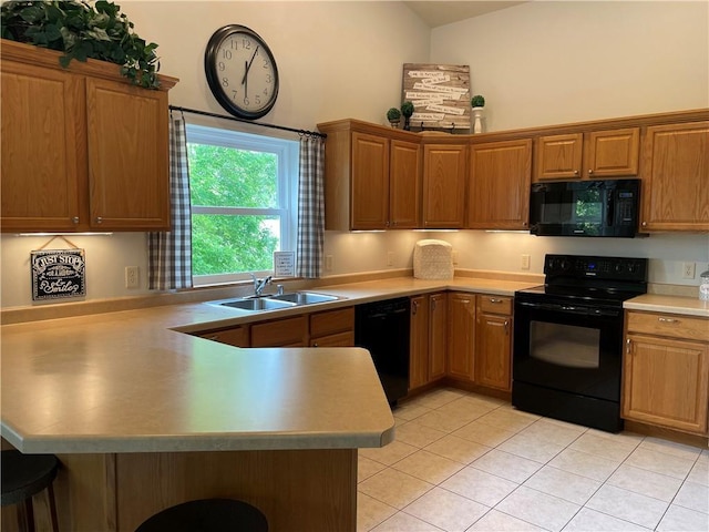 1762 Wilson Ave, Menomonie, WI 54751 - kitchen with black appliances, a sink, a peninsula, a breakfast bar area, and light tile patterned floors