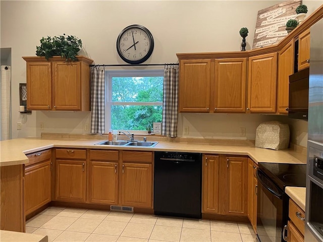 1762 Wilson Ave, Menomonie, WI 54751 - kitchen with black appliances, a sink, light countertops, and light tile patterned floors