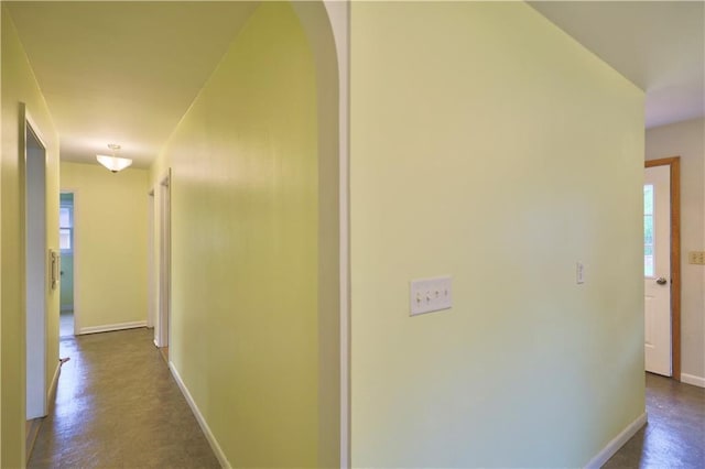 3053 Jupiter Ave, Eau Claire, WI 54703 - hallway with baseboards, plenty of natural light, arched walkways, and concrete floors