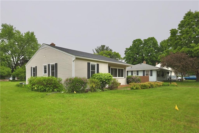 3053 Jupiter Ave, Eau Claire, WI 54703 - rear view of property featuring a chimney and a lawn