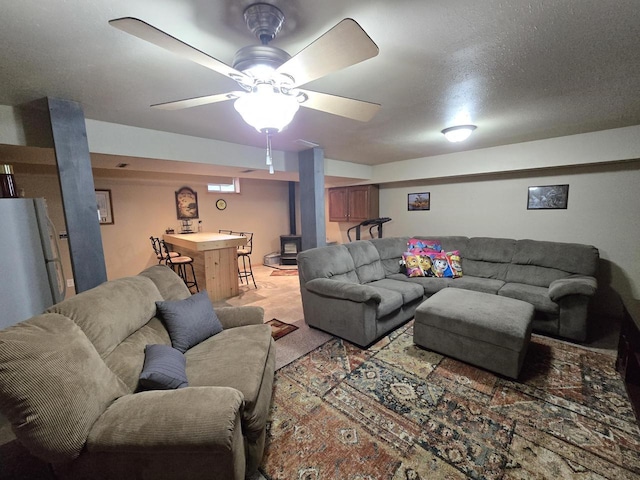 5321 Breezy Pine Dr, Wisconsin Rapids, WI 54494 - living area featuring a wood stove, light carpet, bar area, and ceiling fan