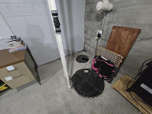 5321 Breezy Pine Dr, Wisconsin Rapids, WI 54494 - bathroom featuring unfinished concrete floors and concrete block wall