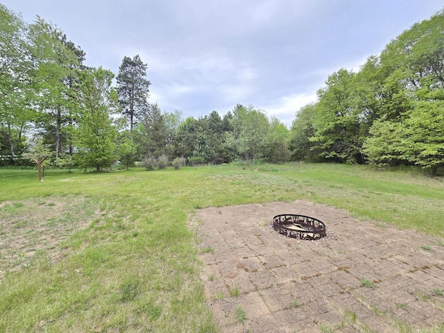 5321 Breezy Pine Dr, Wisconsin Rapids, WI 54494 - view of green lawn with an outdoor fire pit