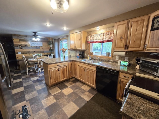 5321 Breezy Pine Dr, Wisconsin Rapids, WI 54494 - kitchen featuring dishwasher, a sink, wooden walls, ceiling fan, and a peninsula