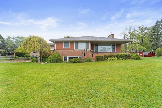 5743 Island View Ct, Waterford, WI 53185 - single story home with a chimney, a front yard, and brick siding