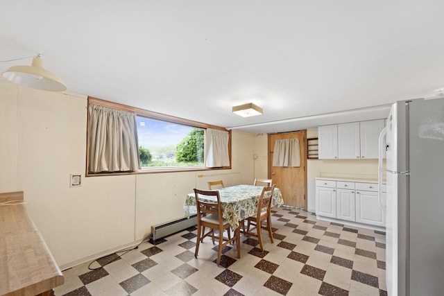 5743 Island View Ct, Waterford, WI 53185 - dining area with light floors and a baseboard heating unit