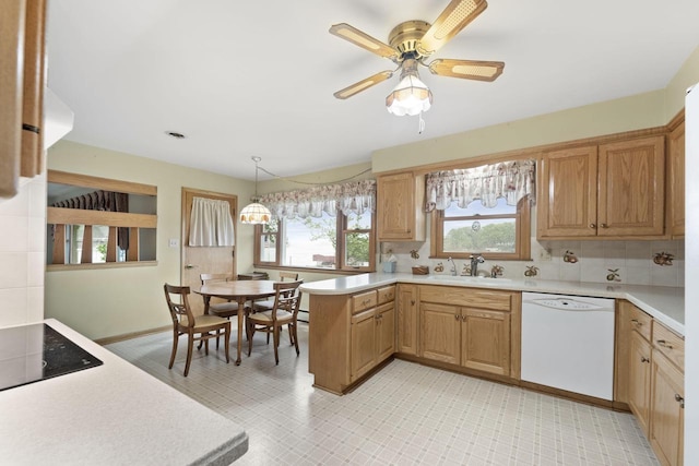 5743 Island View Ct, Waterford, WI 53185 - kitchen featuring white dishwasher, light countertops, a peninsula, and a sink