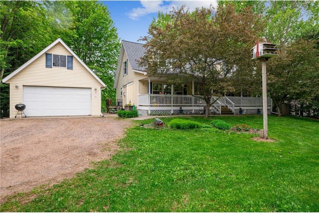 2322 243rd Ave, Cushing, WI 54006 - view of front of home featuring a detached garage, a front yard, a porch, and an outdoor structure