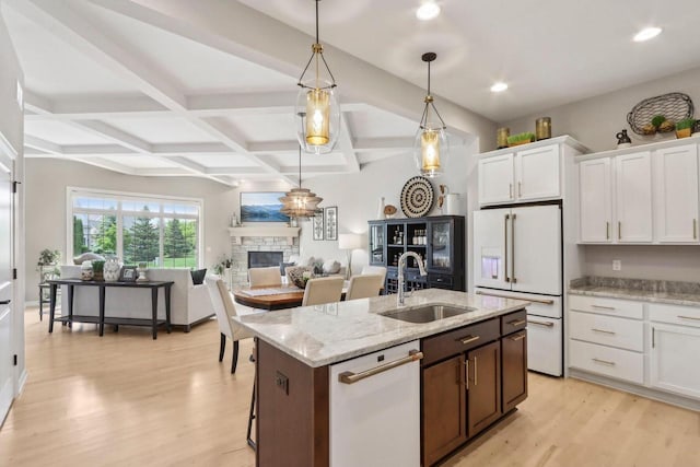 1766 Derby Ln, Oconomowoc, WI 53066 - kitchen featuring white appliances, a sink, a fireplace, light wood-style floors, and coffered ceiling