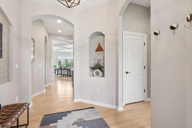 1766 Derby Ln, Oconomowoc, WI 53066 - corridor with light wood finished floors, arched walkways, and baseboards