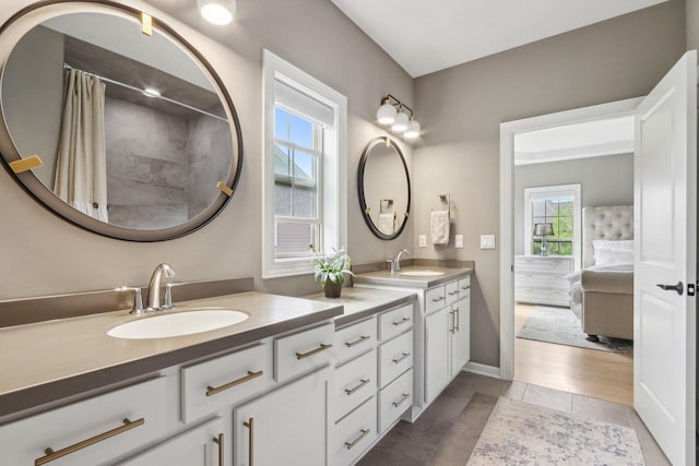 1766 Derby Ln, Oconomowoc, WI 53066 - bathroom featuring double vanity, ensuite bathroom, tile patterned floors, a shower with shower curtain, and baseboards