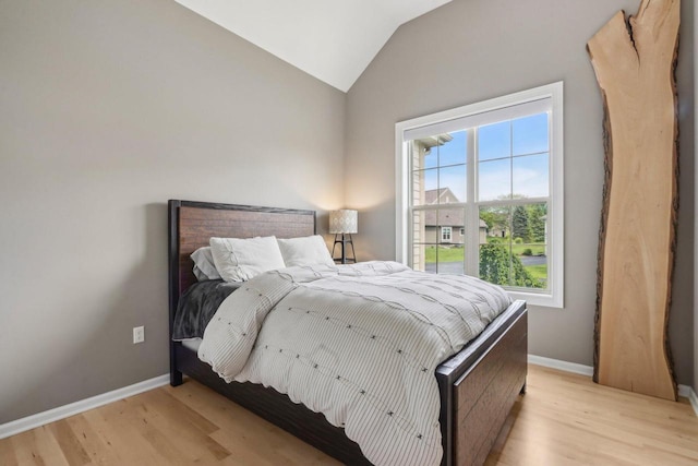 1766 Derby Ln, Oconomowoc, WI 53066 - bedroom featuring light wood-type flooring, lofted ceiling, and baseboards