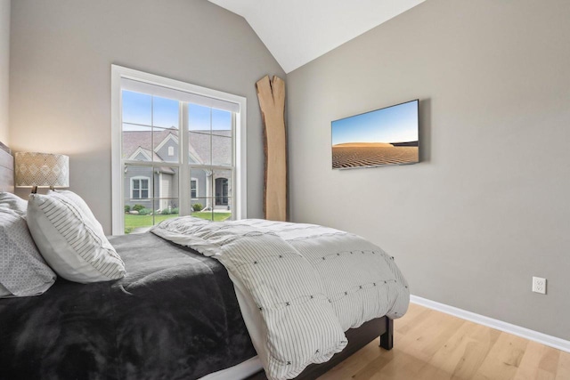 1766 Derby Ln, Oconomowoc, WI 53066 - bedroom with light wood-style flooring, lofted ceiling, and baseboards