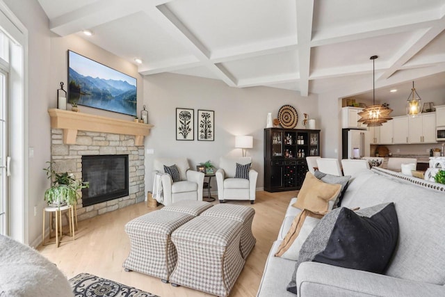 1766 Derby Ln, Oconomowoc, WI 53066 - living area featuring coffered ceiling, beam ceiling, a fireplace, and light wood-style floors