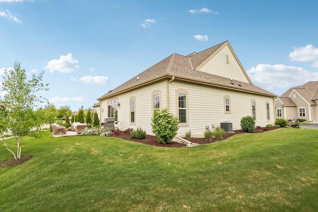 1766 Derby Ln, Oconomowoc, WI 53066 - view of home's exterior featuring an outdoor hangout area, a lawn, and central AC unit