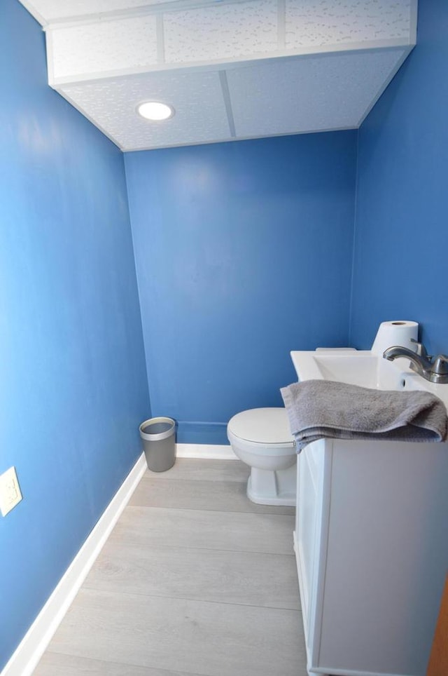 1781 Spruce Ct, South Milwaukee, WI 53172 - bathroom with baseboards, wood finished floors, toilet, and vanity