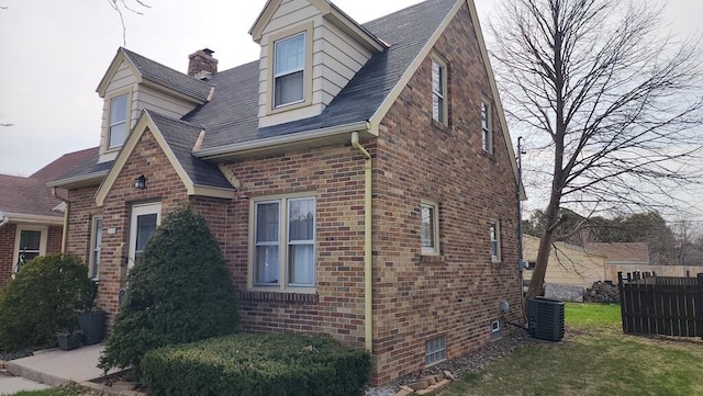 2126 S 16th St, Sheboygan, WI 53081 - view of home's exterior featuring brick siding, central AC unit, and roof with shingles