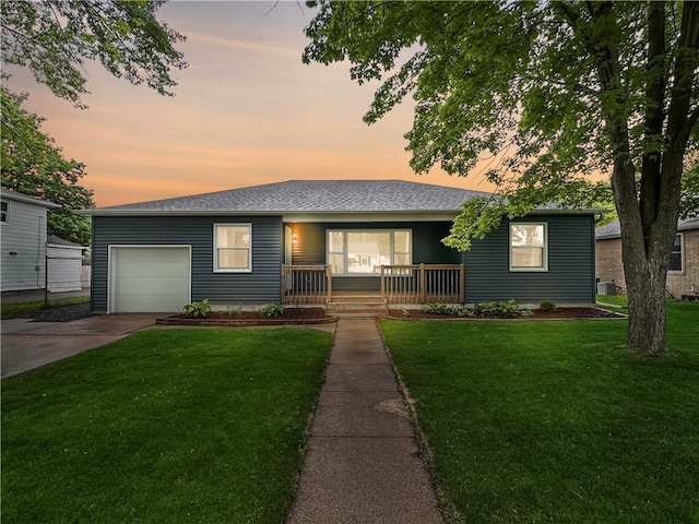 1708 Rist Ave, Eau Claire, WI 54701 - ranch-style home with covered porch, a lawn, concrete driveway, and an attached garage