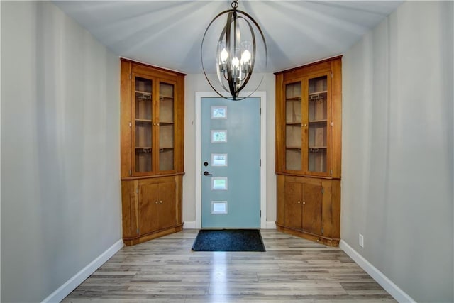 1708 Rist Ave, Eau Claire, WI 54701 - entryway with a chandelier, light wood finished floors, and baseboards