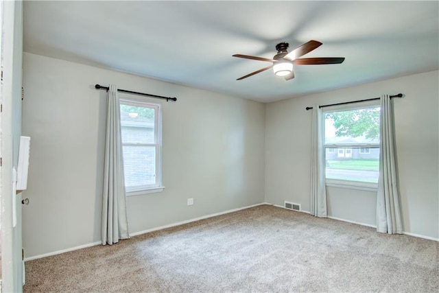 1708 Rist Ave, Eau Claire, WI 54701 - empty room featuring healthy amount of natural light, carpet flooring, and a ceiling fan
