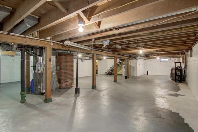 1708 Rist Ave, Eau Claire, WI 54701 - unfinished basement with stairway, electric water heater, and heating unit