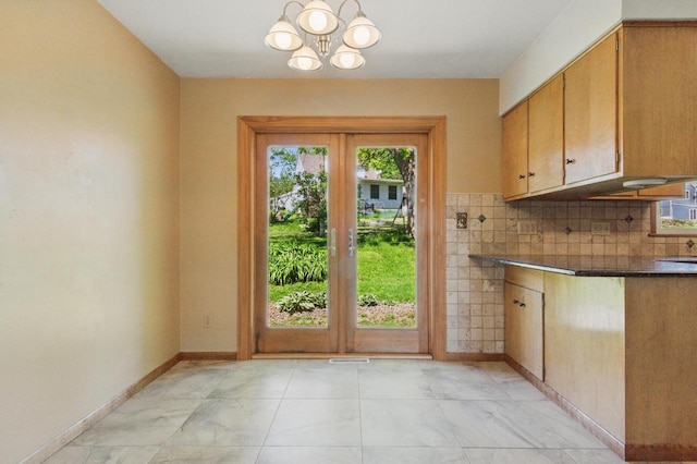 106 Elm St, Westby, WI 54667 - doorway to outside featuring a chandelier and baseboards