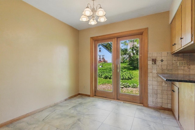 106 Elm St, Westby, WI 54667 - entryway with french doors, a chandelier, and baseboards