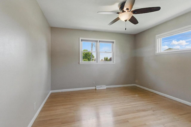 106 Elm St, Westby, WI 54667 - empty room with healthy amount of natural light, light wood-style flooring, a ceiling fan, and baseboards