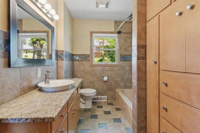 106 Elm St, Westby, WI 54667 - bathroom with vanity, healthy amount of natural light, toilet, bathing tub / shower combination, and tile walls