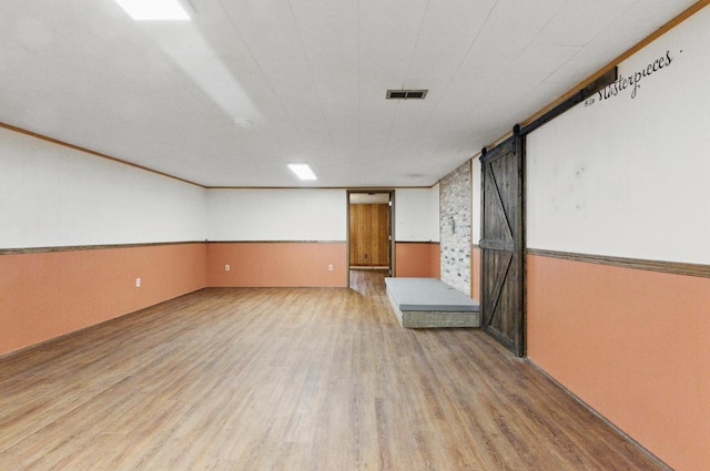 106 Elm St, Westby, WI 54667 - finished basement featuring light wood-style flooring and wainscoting