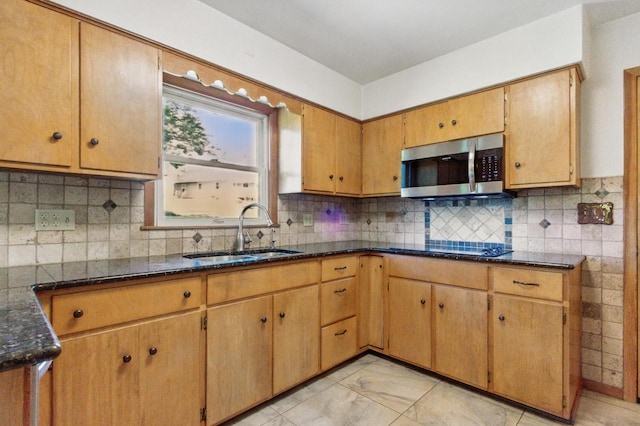 106 Elm St, Westby, WI 54667 - kitchen featuring stainless steel microwave, a sink, dark stone countertops, and decorative backsplash