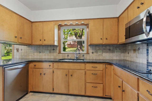 106 Elm St, Westby, WI 54667 - kitchen featuring stainless steel appliances, a sink, dark stone counters, and tasteful backsplash