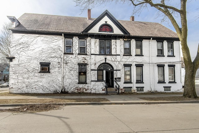 2601 S 8th St Unit 2605, Milwaukee, WI 53215 - townhome / multi-family property featuring a chimney, brick siding, and roof with shingles