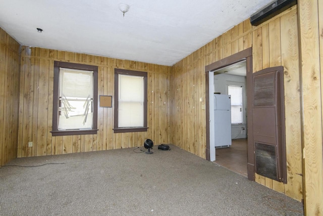 2601 S 8th St Unit 2605, Milwaukee, WI 53215 - unfurnished room with a heating unit, carpet, and wood walls