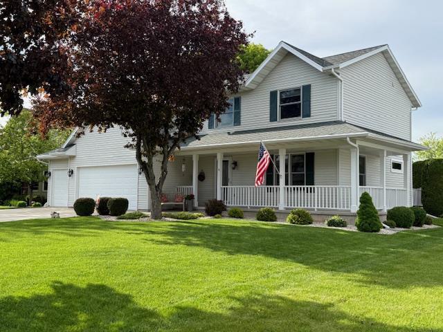 35 Sammy Jo Cir, Fond Du Lac, WI 54935 - country-style home with covered porch, an attached garage, a front yard, and driveway