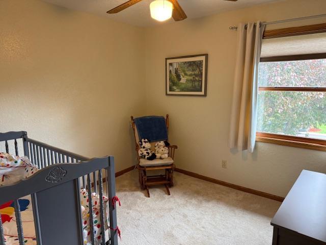 35 Sammy Jo Cir, Fond Du Lac, WI 54935 - carpeted bedroom featuring multiple windows, baseboards, a nursery area, and ceiling fan
