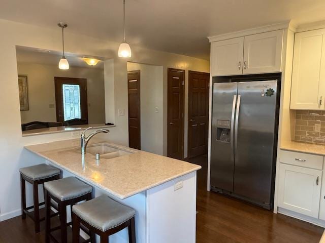 35 Sammy Jo Cir, Fond Du Lac, WI 54935 - kitchen with stainless steel refrigerator with ice dispenser, a sink, dark wood-type flooring, white cabinets, and tasteful backsplash