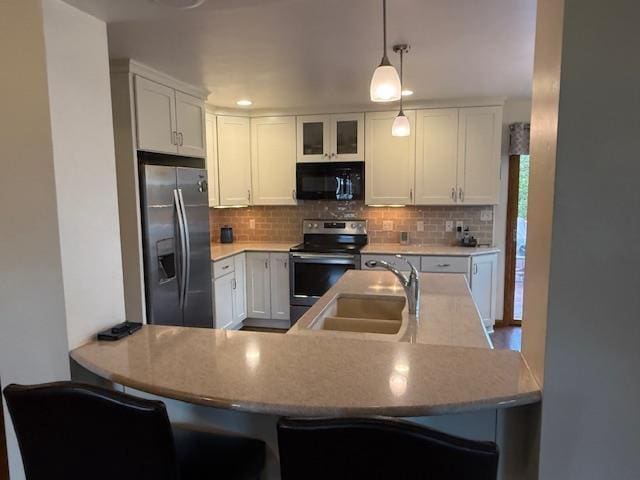 35 Sammy Jo Cir, Fond Du Lac, WI 54935 - kitchen featuring appliances with stainless steel finishes, a sink, decorative backsplash, white cabinetry, and decorative light fixtures