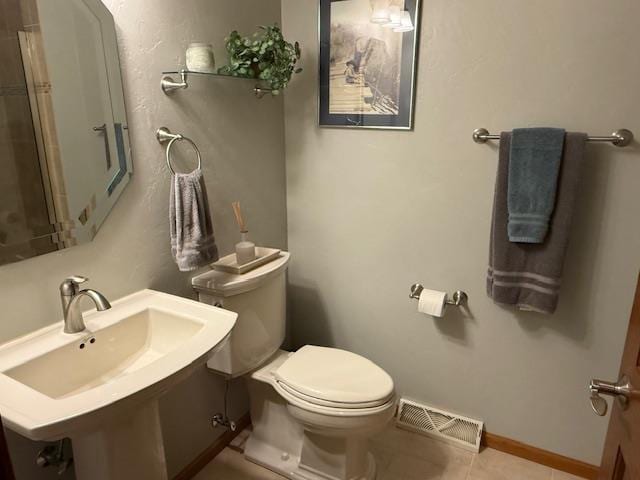 35 Sammy Jo Cir, Fond Du Lac, WI 54935 - bathroom featuring toilet, a sink, tile patterned floors, and baseboards