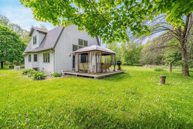 7459 Jensen Rd, Oshkosh, WI 54904 - back of property featuring a gazebo, a wooden deck, a yard, and roof with shingles