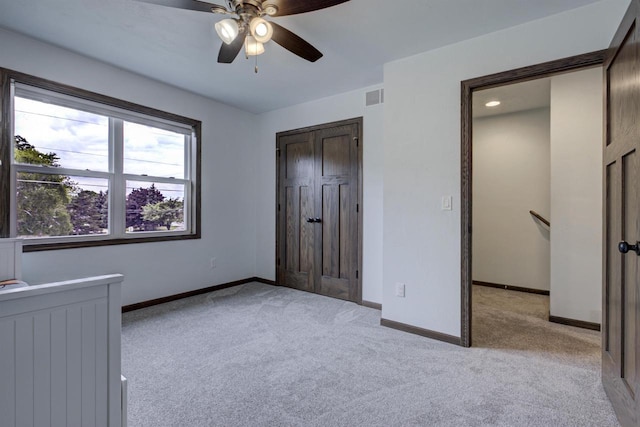 N406 Marion Ave, Appleton, WI 54915 - unfurnished bedroom featuring light colored carpet, baseboards, radiator, and ceiling fan