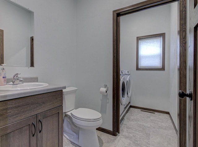 N406 Marion Ave, Appleton, WI 54915 - bathroom featuring washer and clothes dryer, toilet, vanity, and baseboards